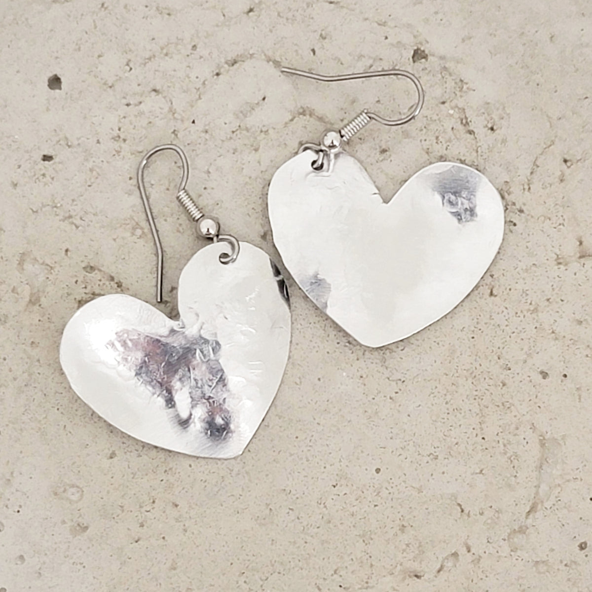 Charmed! Rhodium plate open heart earrings on hypoallergenic surgical –  SeaCycled Glass